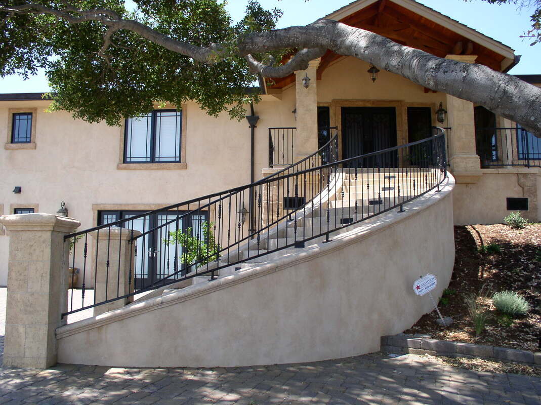 Commercial curved staircase with structural iron railing