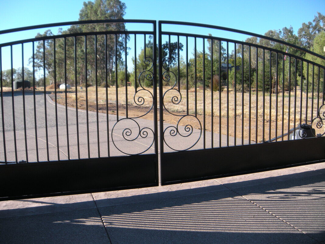 Custom-designed driveway gate built by Hines Custom Fence & Iron