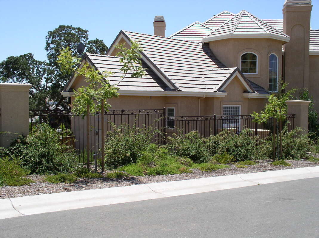 Custom iron backyard fence built by Hines Custom Fence & Iron
