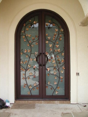 Custom copper leaf detail on an entry door