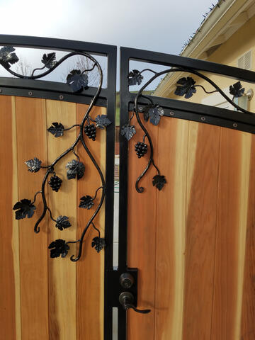 Detail shot of hand-forged grape vine gate scrollwork