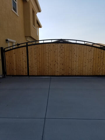 Custom iron and wood driveway gate
