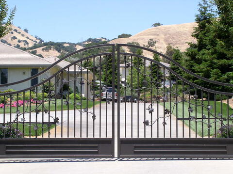 Driveway gate with hand-forged leaves and vines